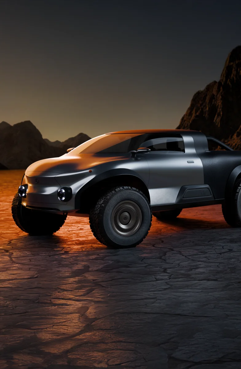 “Lexus EX Concept pickup truck parked on cracked desert ground with mountains in the background, lit by a warm sunset glow.