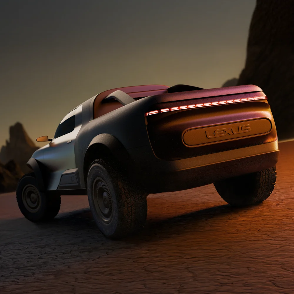 Rear three-quarter view of the Lexus EX Concept pickup on a desert road at sunset, showing its wide tires, sculpted body, and illuminated rear light bar.