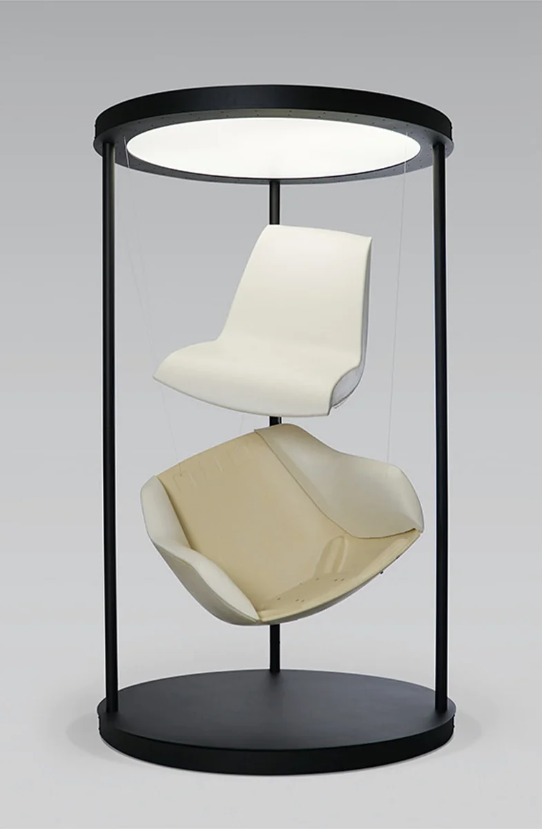 Terra Lounge armchair components suspended within a circular display frame, showing the outer shell and inner foam construction.