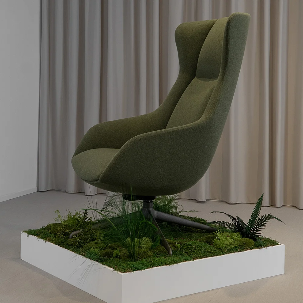Terra Lounge armchair detail showing wooden leg set into a planter with moss and grasses, highlighting the natural installation elements.