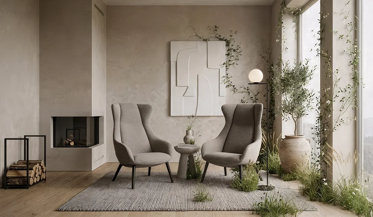 Two Terra Lounge armchairs sit in a warm residential interior surrounded by natural greenery, soft neutral tones and floor to ceiling windows.