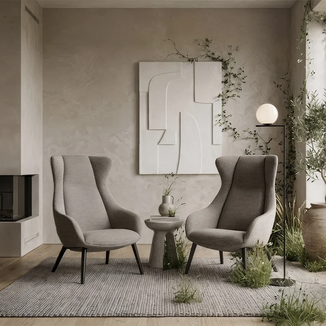 Two Terra Lounge armchairs sit in a warm residential interior surrounded by natural greenery, soft neutral tones and floor to ceiling windows.